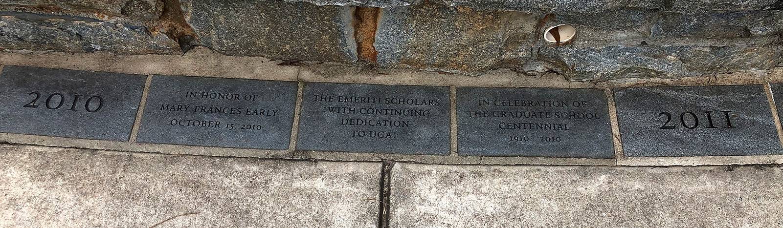 Photograph of a row of granite blocks engraved with peoples' names as a memorial