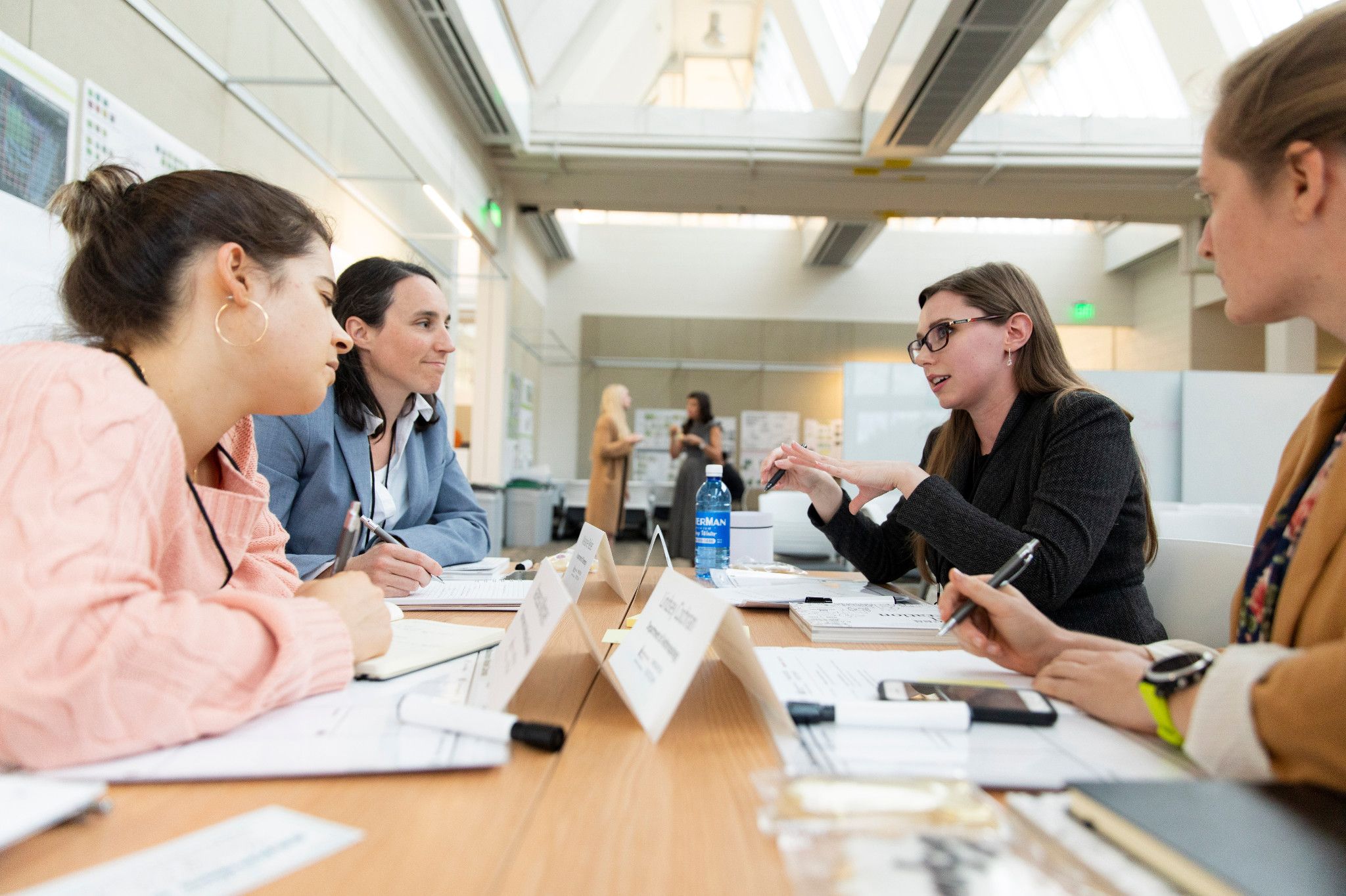 Four people discussing something at a table