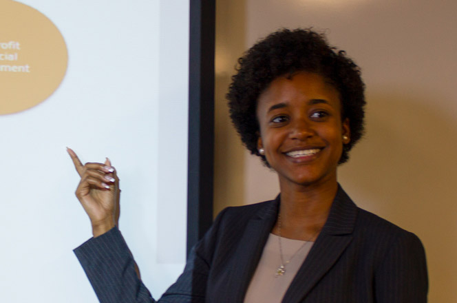 A women pointing something out on a projector screen